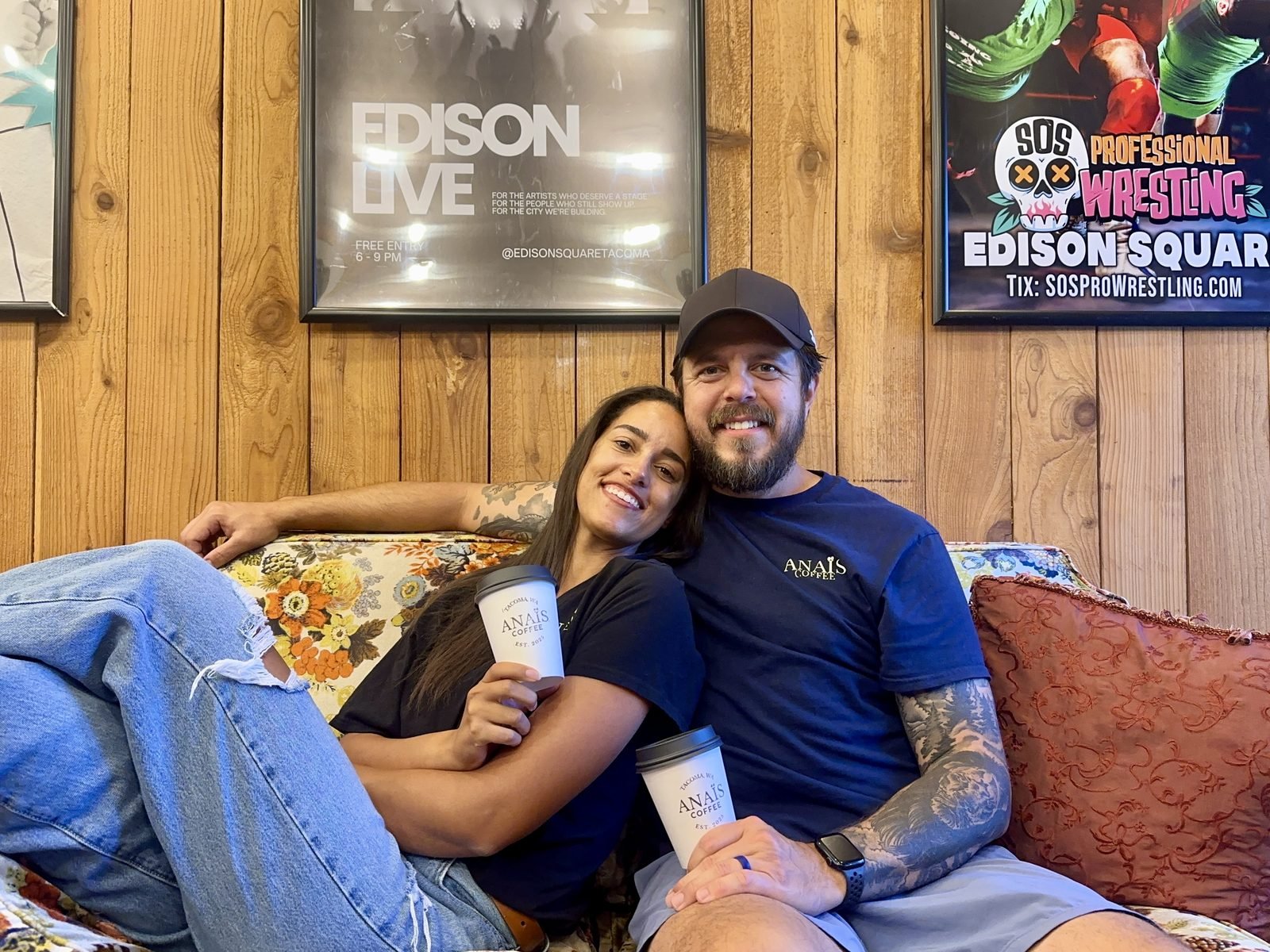 Kaja and Jay, cofounders of Anaïs Coffee, sitting together with Anaïs branded cups inside Edison Square.